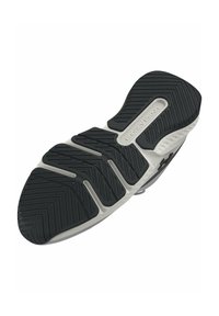 Black rubber shoe sole features textured grip patterns and a grey accent with "Under Armour" branding. Curved and designed for traction.