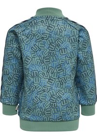 Grön jacka med ett heltryck av geometriska mönster i blått och svart. Ribbad krage och manschetter, mjuk textur och en avslappnad, sportig design.