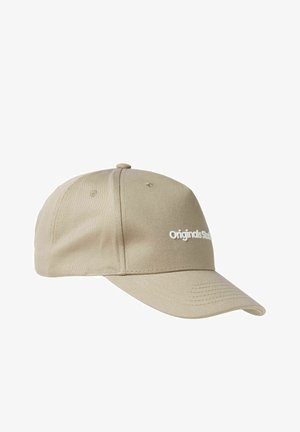 Casquette de baseball beige avec une visière incurvée, texture en tissu, et un logo "Originals" brodé en blanc à l'avant, comportant des œillets de ventilation.