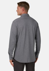 Graues Langarmshirt aus strukturiertem Stoff, mit einem Kentkragen und Knopfmanschetten. Abgerundeter Saum und lockere Passform.