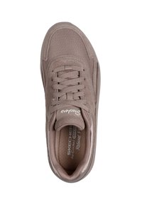 Light brown sneaker with mesh and suede materials, rounded toe, lace-up design, and padded collar. Features "Skechers" branding on tongue.