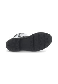 Black rubber sole of a boot, featuring deep tread patterns for grip, with the brand name "Gabor" embossed on the midsole.