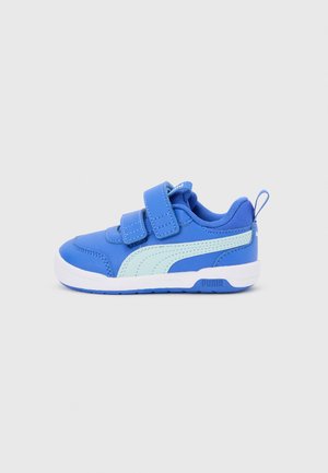 Blå småbørns-sneaker med lys blå Puma-stribe, dobbelte velcrobånd, hvid sål og trækflig ved hælen på grå baggrund.