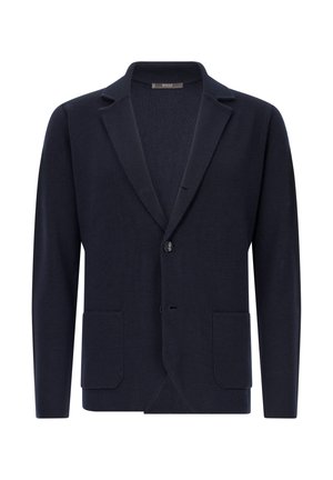 Blazer di maglia navy con rever a punta, chiusura con un bottone e due tasche frontali. Texture morbida e design aderente, adatto per ambienti casual.
