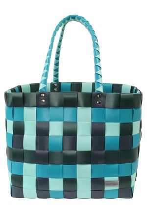 Wabendete Tragetasche in Türkis und Dunkelgrün mit einem Schachbrettmuster, robusten Tragegriffen und metallischen Akzenten an der Basis der Griffe.
