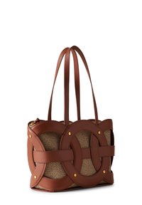 Brown leather tote bag with round woven accents, gold studs, and dual shoulder straps. Textured fabric side and structured base.