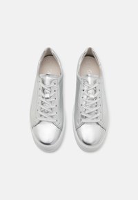 Silver metallic sneakers with a smooth texture, rounded toe, and flat laces. Plain design with a white sole and minimal branding inside.