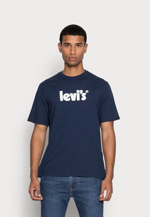 Navy blue cotton T-shirt featuring a white "Levi's" logo, round neckline, and short sleeves, paired with denim jeans. Smooth texture.
