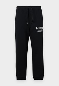 NEVEZ - Tracksuit bottoms - black