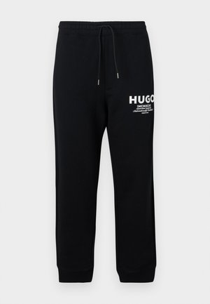 Pantaloni sportivi neri realizzati in cotone misto, dotati di vita con cordoncino, gambe affusolate e logo e testo stampati in bianco sulla coscia sinistra.
