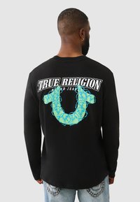 Schwarzes Langarmshirt mit einem großen türkisfarbenen Grafiklogo auf dem Rücken und Text, aus weichem Stoff gefertigt und mit lässiger Passform.