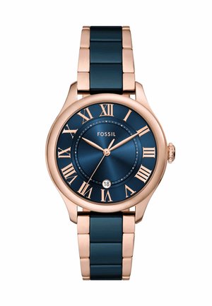 Montre en acier inoxydable rose gold avec un cadran bleu marine, des chiffres romains, une fenêtre de date et un bracelet à maillons bleu marine.