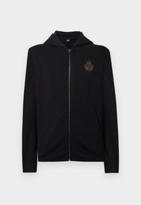 Sweatshirt preta com fecho de correr, feita de mistura de algodão, com um bolso canguru frontal e capuz. Apresenta um logótipo bordado a ouro no lado esquerdo do peito.