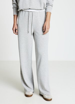 Light gray sweatpants made of soft fabric, featuring a drawstring waist and wide-leg design for a relaxed fit.