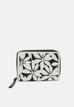 Portefeuille noir et blanc avec un design en découpes florales, texture lisse et fermeture éclair avec un petit accent en pompon.