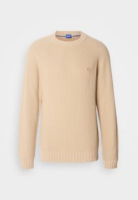 Beige knitted sweater with ribbed cuffs and hem, featuring a round neck and raglan sleeves. Small logo detail on the chest.
