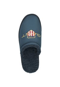 Navy blue slippers with a soft, fluffy interior. Features a red and white striped crown logo and embroidered text on the upper.