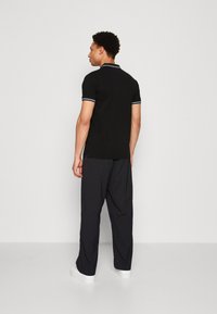 Lindbergh CONTRAST PIPING - Bluză polo - black