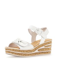 White leather wedge sandal with a bow accent, cork-like midsole, open toe, ankle strap with buckle, and textured outsole.