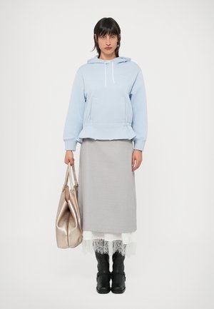 Light blue hooded sweatshirt with a loose fit, gray knee-length skirt with lace trim, black knee-high boots, and a shiny gold handbag.