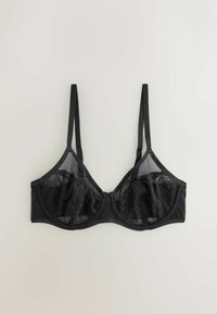 Sort blonde underwired BH med justerbare stropper og halv-gennemsigtige mesh-paneler, lagt fladt ud på en lys baggrund.