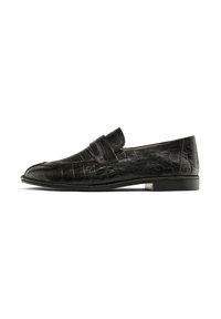 Black loafers with a crocodile leather texture, featuring a prominent strap across the instep, displayed against a white background.