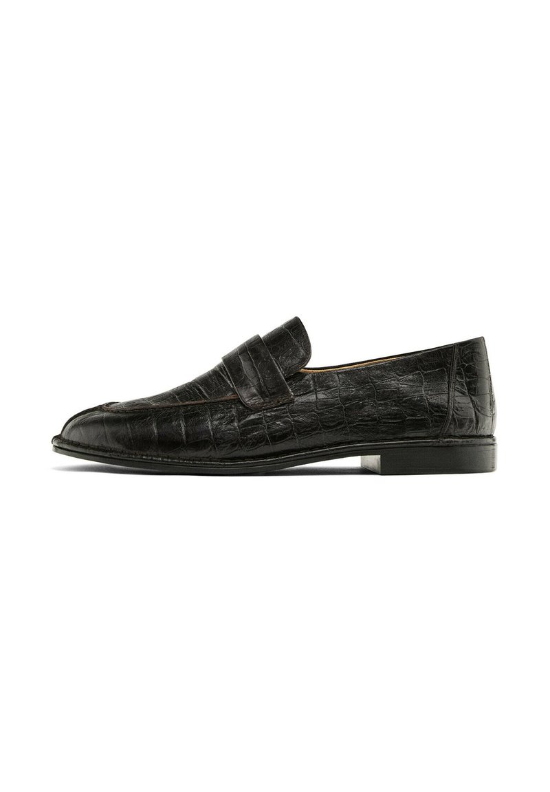 Black loafers with a crocodile leather texture, featuring a prominent strap across the instep, displayed against a white background.