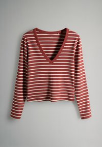Dlhý rukáv, top s hlbokým výstrihom do V v rezavom červenom s bielymi vodorovnými pruhmi. Má mäkkú látku a skrátený lem.
