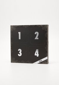 Sort adventskalender i sort karton med sølvnumre fra 1-4, tekstureret snefnugmønster og et hvidt JBS-logo langs den nederste kant.