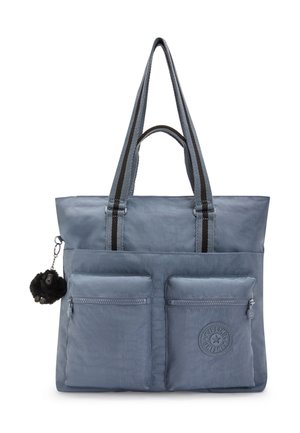 Blue tote bag with dual front zip pockets, black striped handles, and a small black plush monkey keychain attached on the side.