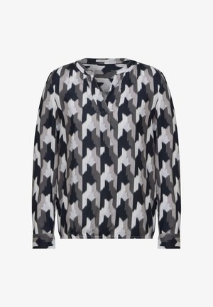 Langarm blouse van een lichte stof met een geometrisch patroon in zwart, grijs en wit, voorzien van een V-halslijn en manchetten.