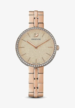 Rožinė auksinė rankinė laikrodis su apvaliu korpusu, blizgia smėlio spalvos ciferblatu, kristalų puoštu rėmeliu ir sujungta metaline apyranke. Ypatybė – minimalistiniai rodyklės.