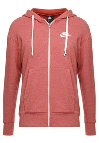 Red zip-up hoodie with white drawstrings and Nike logo. Made from a soft, textured fabric with two front pockets and ribbed cuffs.