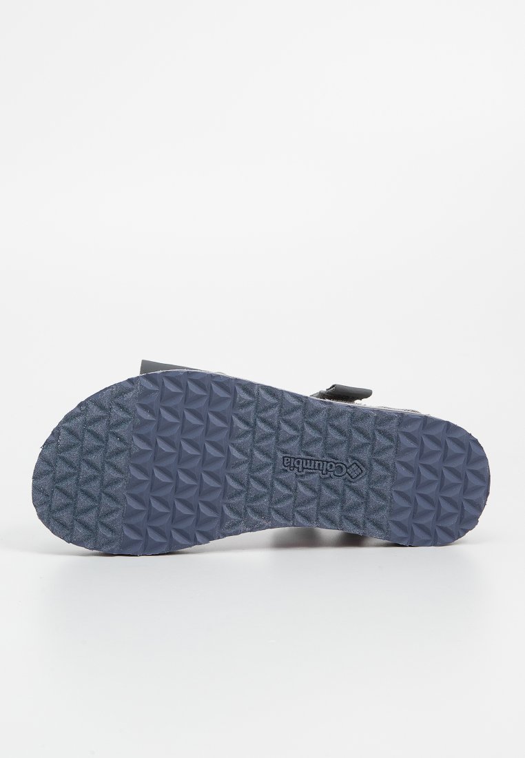 Columbia-Sandalen mit einer strukturierten, dunkelblauen Gummisohle im Diamantmuster und einem verstellbaren Riemen für einen sicheren Sitz.