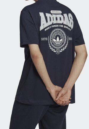 Navyblauwe katoenen t-shirt met een groot wit grafisch ontwerp op de achterkant, inclusief tekst en een lauwerenkransmotief. Korte mouwen.