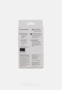 Emballage Polaroid Hi-Print ; carton gris et blanc, texte multilingue, avec un onglet de suspension. Contient 20 feuilles de papier photo de 2x3 pouces.