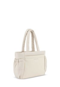 Beige kantokassi, jossa on kaksi pehmustettua kahvaa ja etutasku. Liukas pinta ja pyöreä muoto tarjoavat rentoa ja toiminnallista muotoilua.