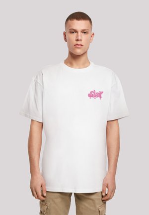 White cotton t-shirt with short sleeves, featuring a pink graphic design on the left chest. Casual fit, smooth texture.