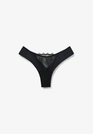 Black thong made of a smooth fabric with a lace panel at the front and mesh detailing at the back. Features a low-rise cut.