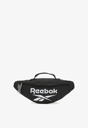 Riñonera negra de Reebok con logo blanco, asa superior y compartimento principal con cremallera sobre fondo blanco.