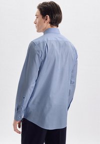Camicia azzurra a maniche lunghe con colletto classico, polsini con bottoni e tessuto morbido con una sottile texture. Vista posteriore mostrata.