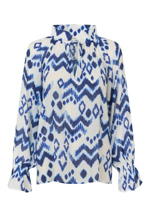 Blouse à motifs bleu et blanc avec un col montant, un détail à nouer et des manches longues avec des poignets froncés. Fabriquée en tissu léger.