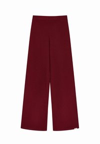 Bordeaux wijde broek gemaakt van zachte, geribbelde stof. Voorzien van een elastische tailleband en een gladde textuur zonder zichtbare patronen.