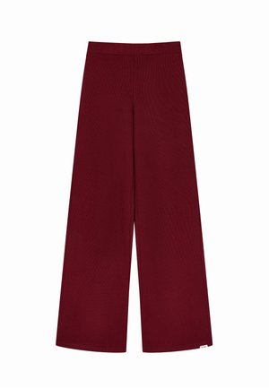Pantalones de pierna ancha burdeos hechos de un tejido suave y acanalado. Con una cinturilla elástica y una textura lisa sin patrones visibles.