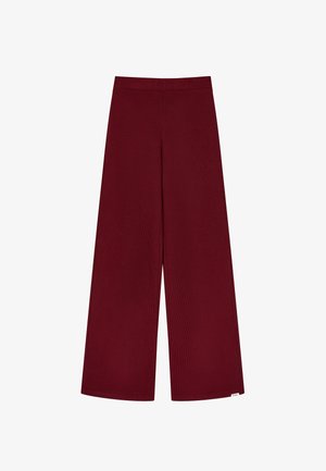 Pantalones de pierna ancha burdeos hechos de un tejido suave y acanalado. Con una cinturilla elástica y una textura lisa sin patrones visibles.