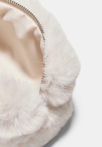 White faux fur pouch with a soft texture, zip closure, and fluffy trim. Interior features a smooth fabric lining in a light color.