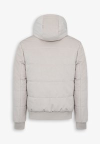 Puffetjakke i lys beige med en tætsiddende hætte. Har horisontale kviltede mønstre, ribbede manchetter og forneden for ekstra varme.