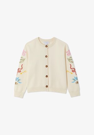 Cardigan crème avec des boutons marron et des motifs brodés colorés sur les manches, comprenant des fleurs, des feuilles, une clé, un serpent rouge et un œil.