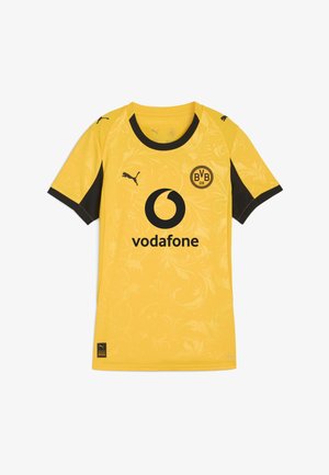 Sárga sportmez fekete akcentusokkal. Virágmintás dizájn és középső logó jellemzi. Szintetikus anyagból készült, rövid ujjakkal.