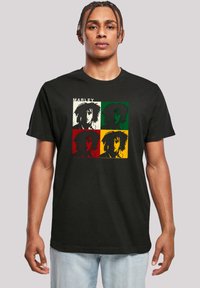 Black cotton t-shirt featuring a square graphic design with four color-blocked images, each depicting a stylized face, along with the text "MARLEY."
